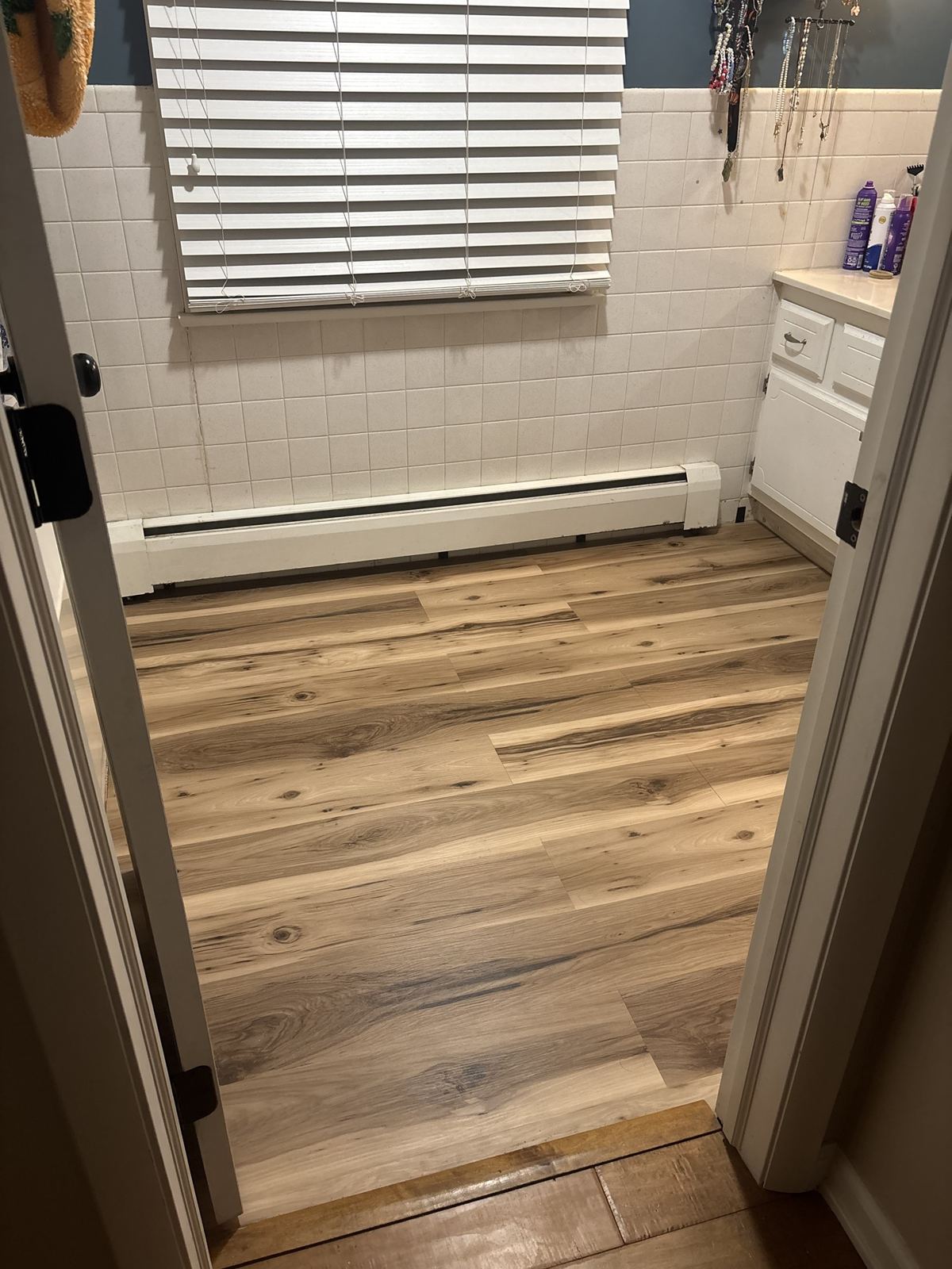 Same bathroom with new wood-look vinyl plank floor