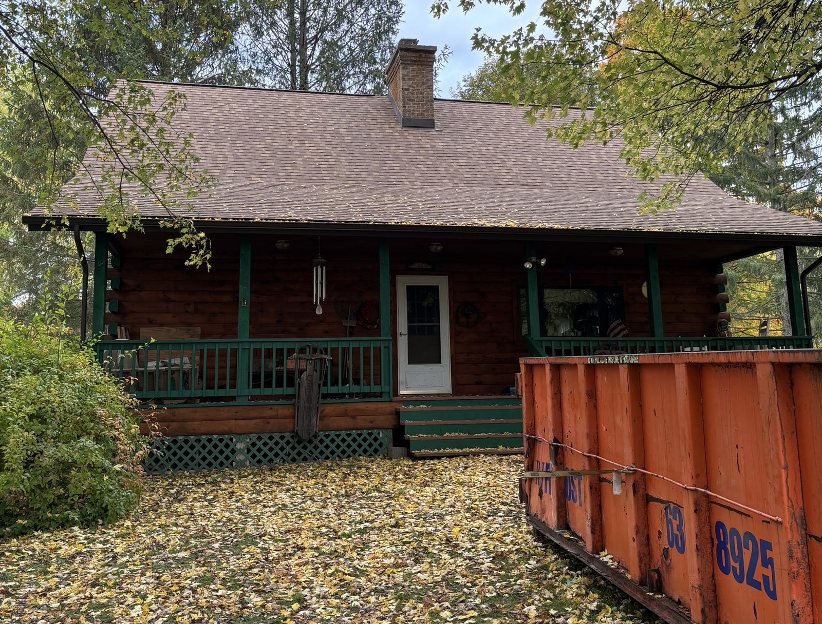 New asphalt shingle roof on a log home